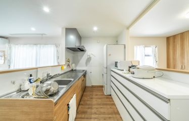 家の中を一望できるキッチン。カップボードや調理家電は白で統一して明るく清潔感のある空間に。