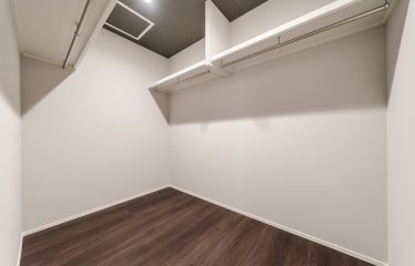 寝室からつながるモルタル調の天井が、ウォークインクローゼットにも上質な空気感を。収納空間にも、デザインのこだわりを感じさせます。